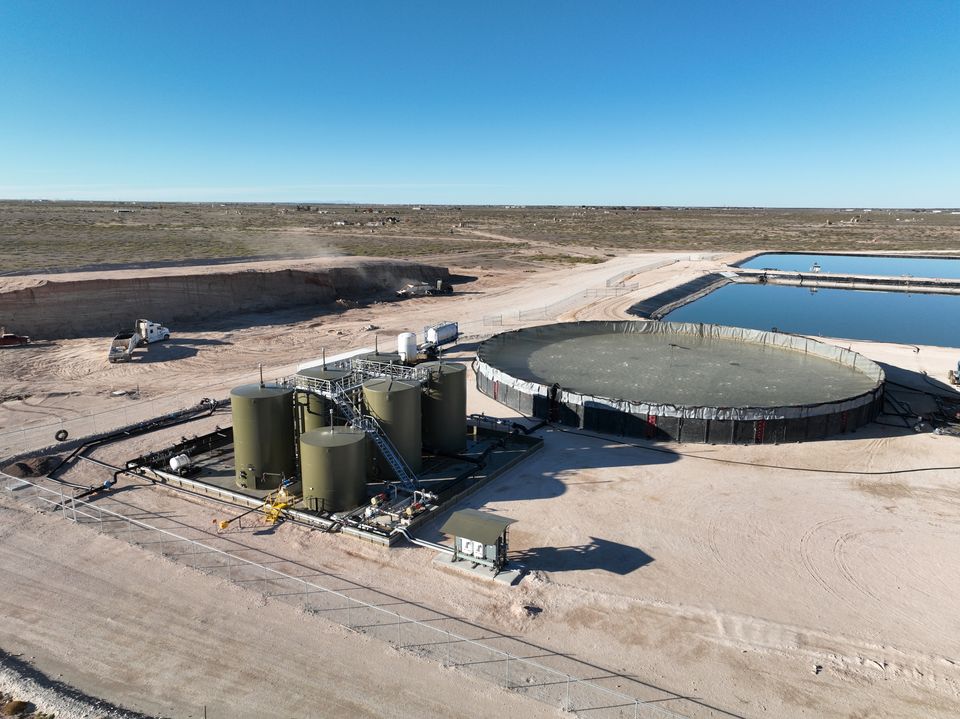 Lea County tank battery beside above-ground storage and ponds
